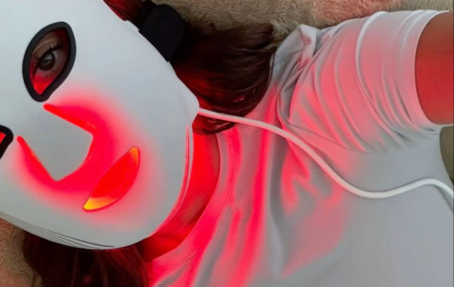 Person wearing a white face mask with red lights and 'Yoodermask' branding.